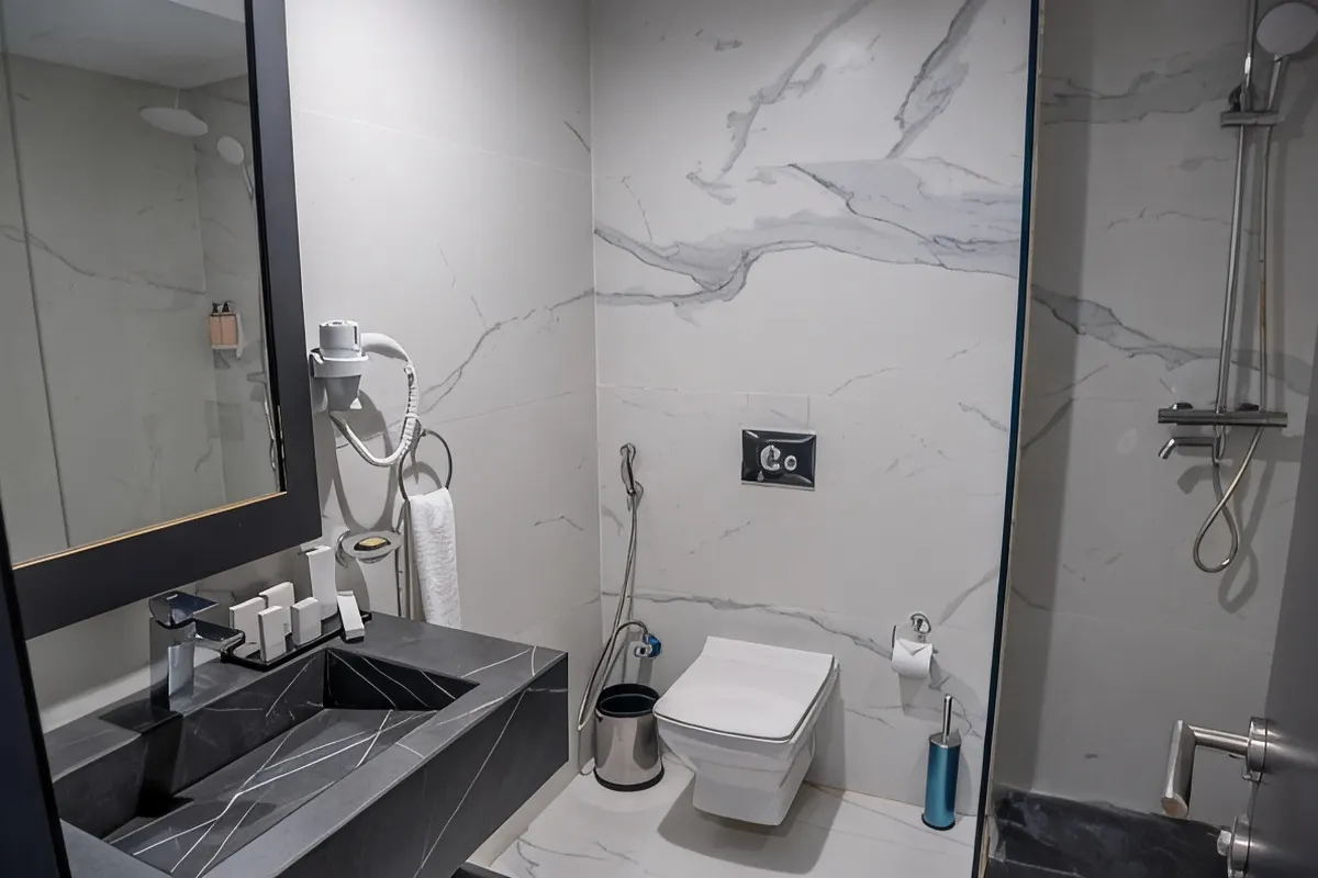 Marble-tiled private bathroom with walk-in shower