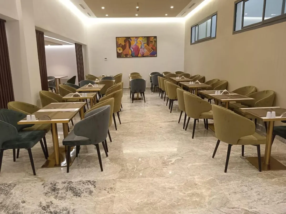 Hotel breakfast room with dining tables and chairs