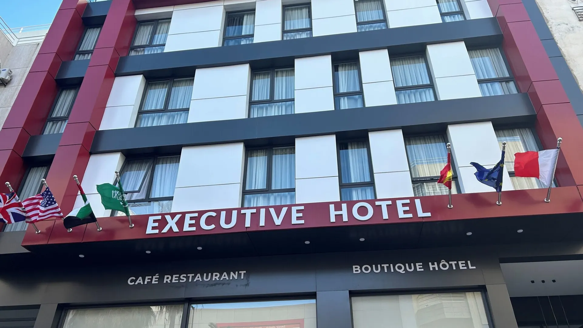 Street-level view of the Executive Hotel building facade, a boutique hotel and café restaurant in Rabat